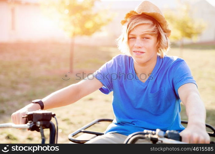 Boy riding farm truck in vineyard. Boy wearing hat and riding farm truck in vineyard