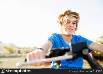 Boy riding farm truck in vineyard. Boy wearing hat and riding farm truck in vineyard