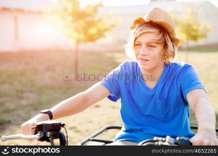 Boy riding farm truck in vineyard. Boy wearing hat and riding farm truck in vineyard