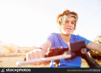 Boy riding farm truck in vineyard. Boy wearing hat and riding farm truck in vineyard