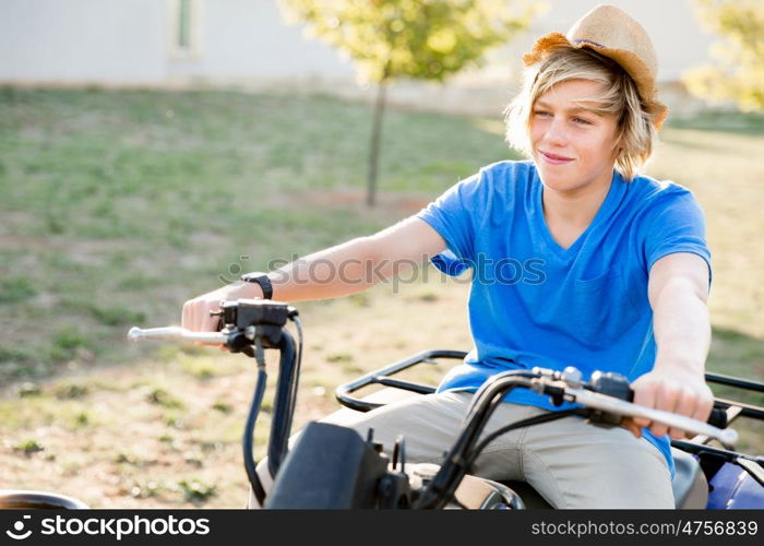 Boy riding farm truck in vineyard. Boy wearing hat and riding farm truck in vineyard