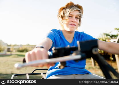 Boy riding farm truck in vineyard. Boy wearing hat and riding farm truck in vineyard