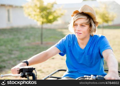 Boy riding farm truck in vineyard. Boy wearing hat and riding farm truck in vineyard