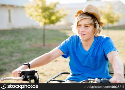 Boy riding farm truck in vineyard. Boy wearing hat and riding farm truck in vineyard