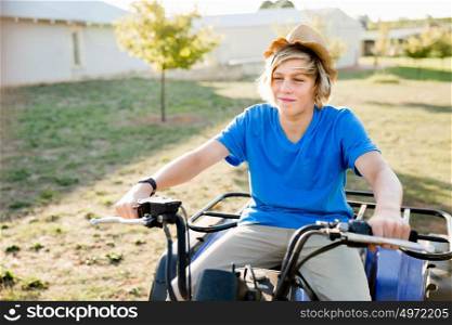 Boy riding farm truck in vineyard. Boy wearing hat and riding farm truck in vineyard