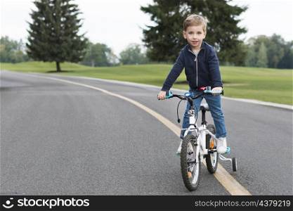 boy riding his bike front view