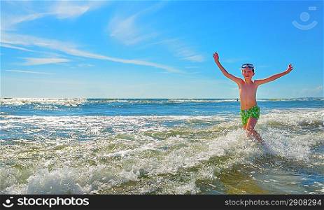 boy running through the water