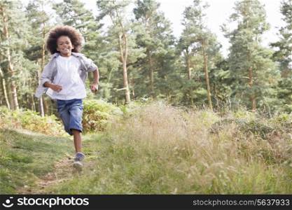 Boy Running Through Woods