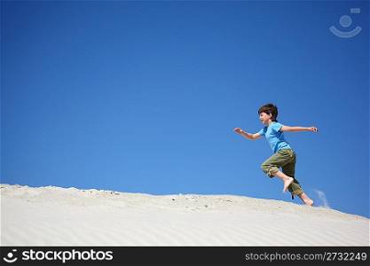 boy runs on sand