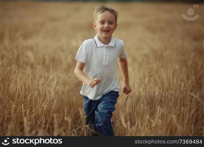 boy runs through a wheat field