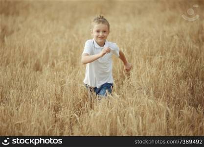 boy runs through a wheat field
