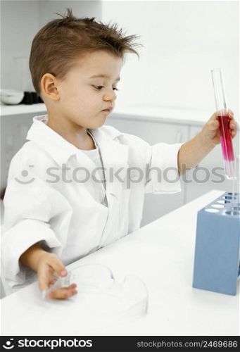 boy scientist laboratory with test tubes