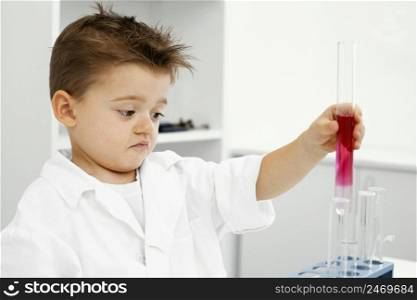 boy scientist laboratory with test tubes doing experiments