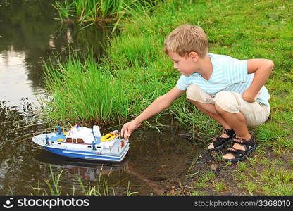 boy sends toy ship in floating