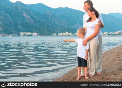 boy showing his parents at sea