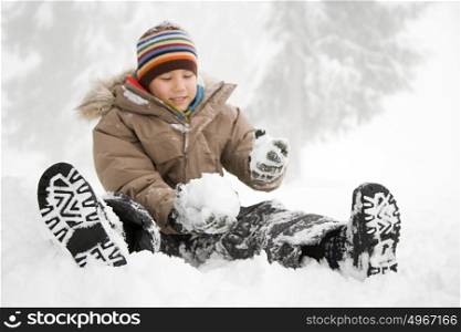 Boy sitting in the snow