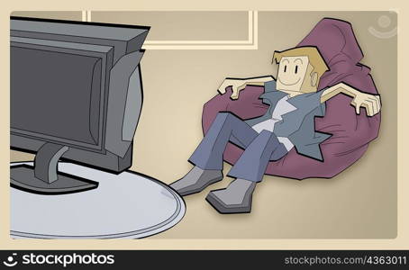 Boy sitting on a bean bag watching television