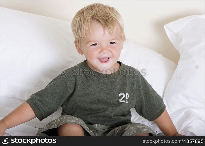 Boy sitting on a bed