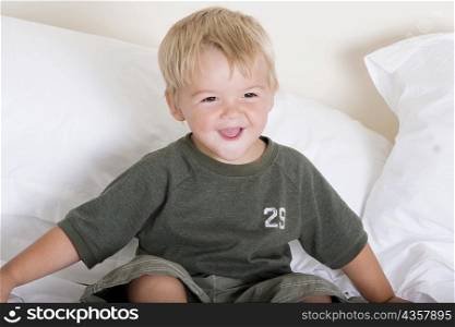 Boy sitting on a bed