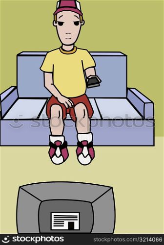 Boy sitting on a couch and watching television