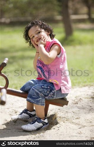 Boy sitting on a see-saw
