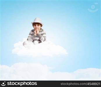 Boy sitting on cloud. Image of little cute boy smiling sitting on clouds