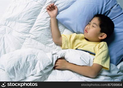 Boy sleeping in a bed