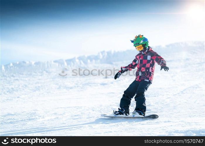 Boy Snowboarding in a Mountain Top Winter Resort