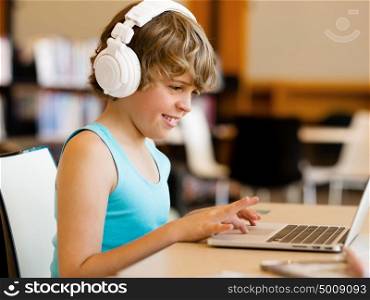 Boy spending time with notebook and modern technology. Boy spending time with notebook