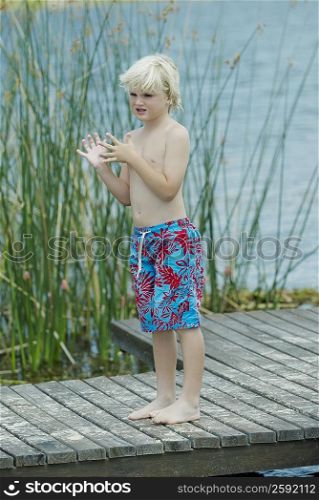 Boy standing on a pier
