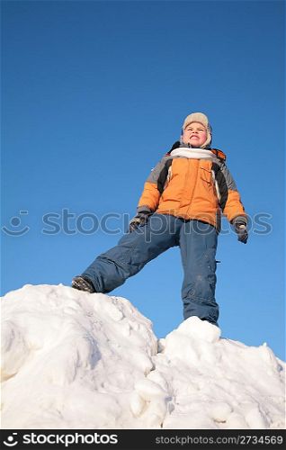 boy stands on snow hill