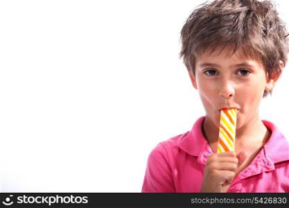 Boy sucking on a lollipop