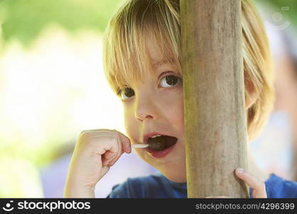 Boy sucking on lollipop