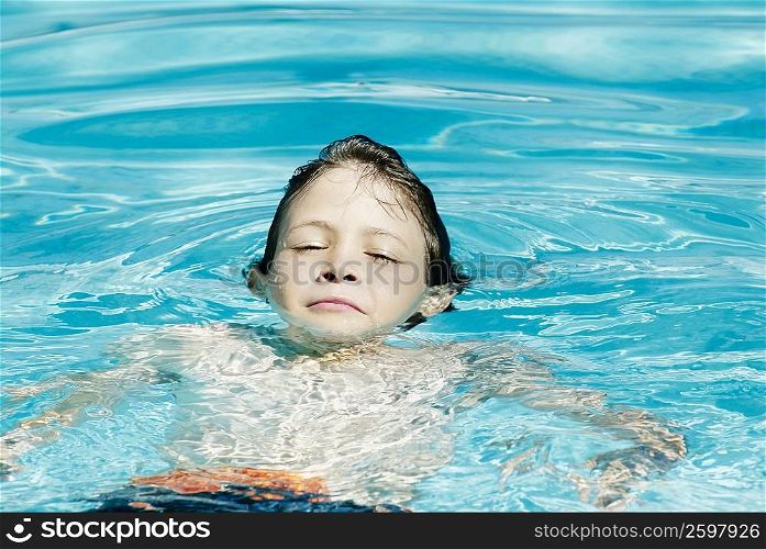 Boy swimming in a swimming pool