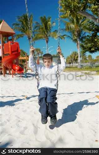 Boy swinging on a swing