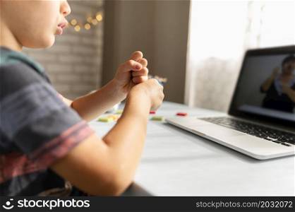 boy talking with his teacher online school