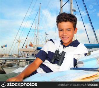 boy teen sailor laying on marina boat chart map smiling in summer vacation
