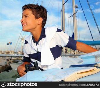 boy teen sailor sitting on marina boat chart map smiling in summer vacation