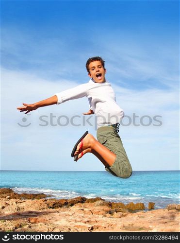 boy teenager high fly jump on beach blue sky summer vacation