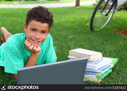 boy teenager homework studying laying green grass garden bycicle background