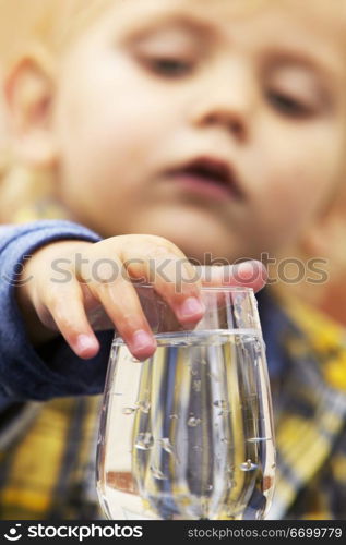 Boy Touching Water Glass