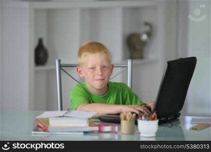 Boy using a laptop at a table