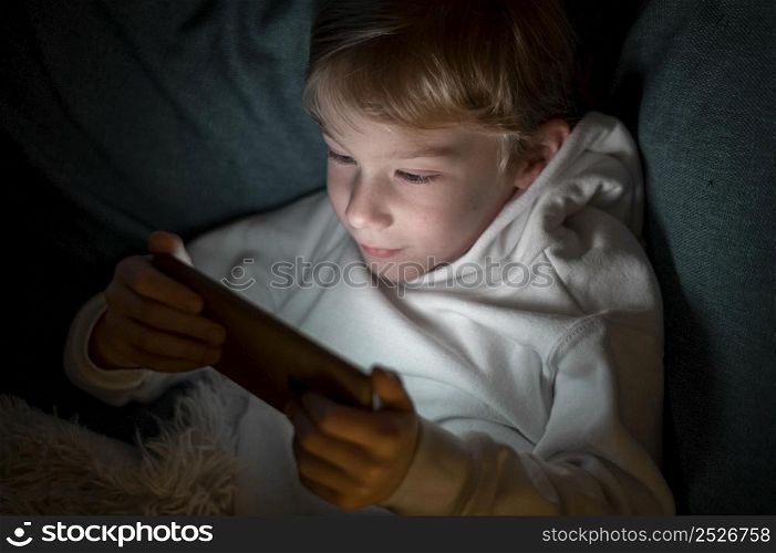 boy using smartphone bed night