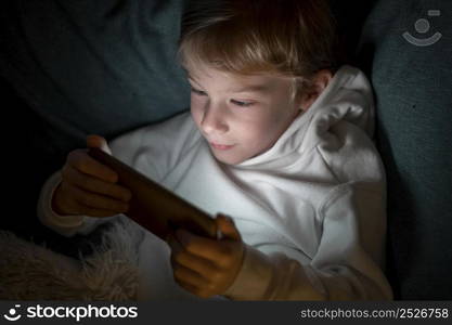 boy using smartphone bed night