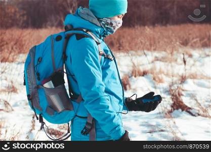 Boy using the mobile phone during the winter trip