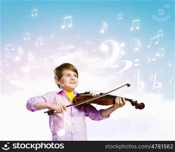 Boy violinist. Image of little cute boy playing on violin against color background