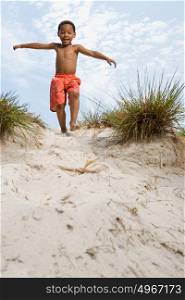 Boy walking down dune