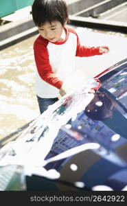 boy washes car