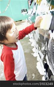 boy washes car