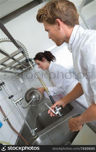 boy washing dishes in the kitchen